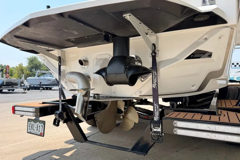 Slide: The Image of 2023 Nautique Super Air Nautique S23 boat stern with propeller and exhaust system. - 6