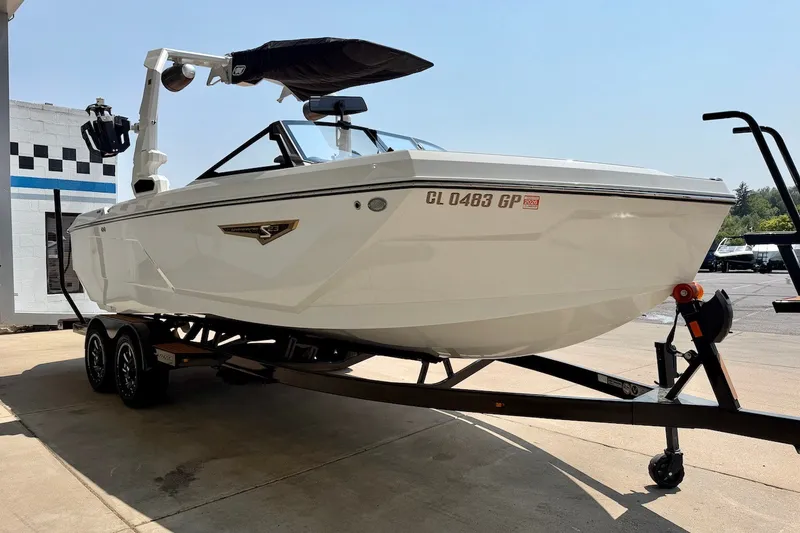 Slide: The Image of 2023 Nautique Super Air Nautique S23 boat on trailer, parked outdoors. - 9
