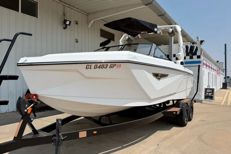 Slide: The Image of 2023 Nautique Super Air Nautique S23 boat on trailer, parked outside a building. - 3