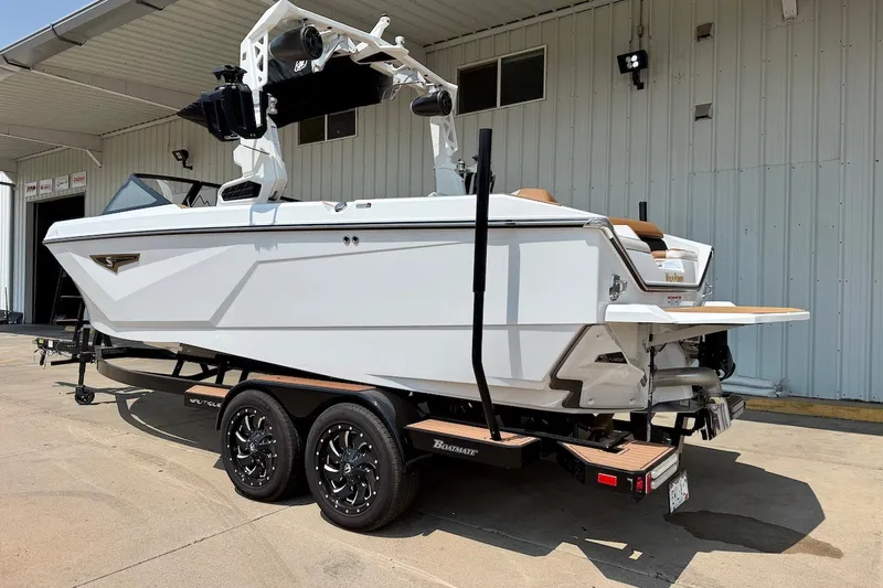 Slide: The Image of 2023 Nautique Super Air Nautique S23 boat on trailer outside a building. - 4
