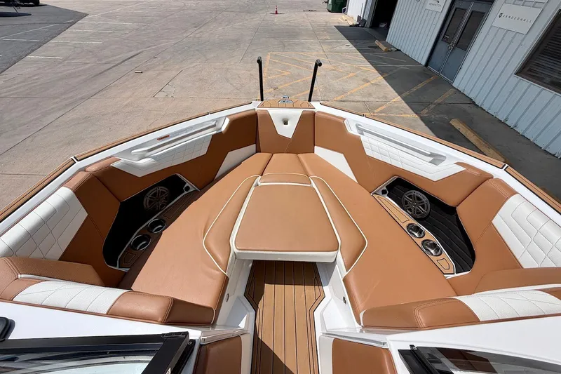 Slide: The Image of 2023 Nautique Super Air Nautique S23 boat interior with tan and white seating. - 18