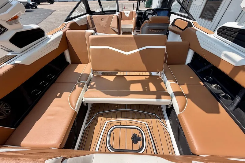 Slide: The Image of Interior of 2023 Nautique Super Air Nautique S23 with tan seating and sleek design. - 26