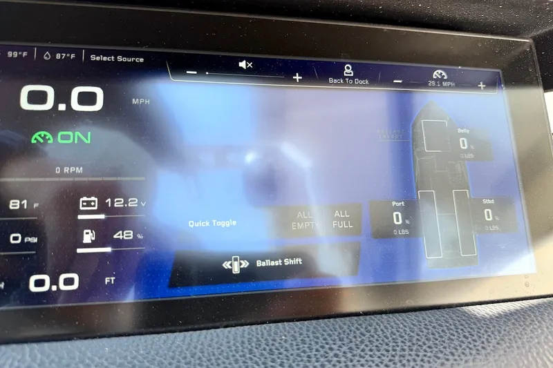 Slide: The Image of 2023 Nautique Super Air Nautique S23 dashboard display showing speed, ballast, and system status. - 17