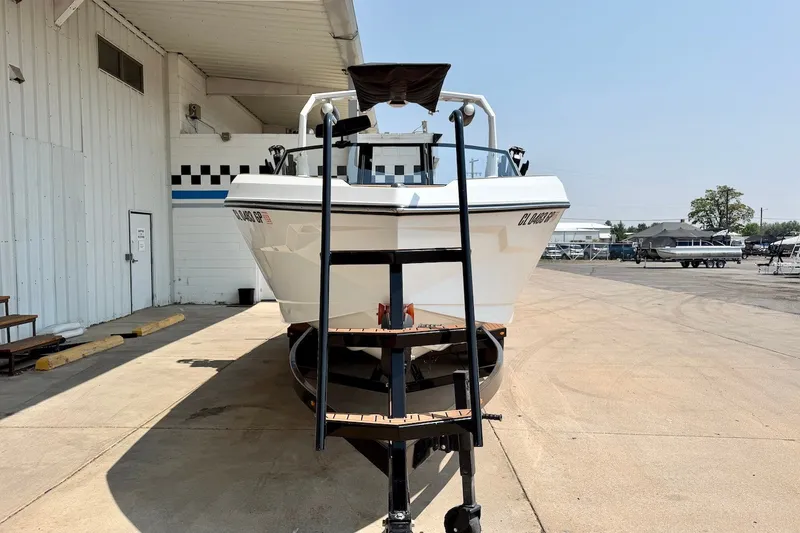 Slide: The Image of 2023 Nautique Super Air Nautique S23 boat on trailer outside a building. - 10