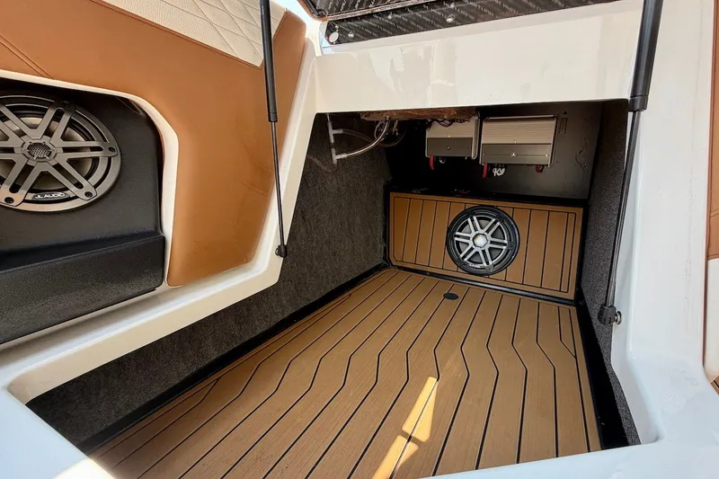 Slide: The Image of 2023 Nautique Super Air Nautique S23 interior with premium audio system and teak flooring. - 23