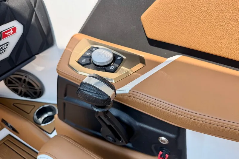 Slide: The Image of 2023 Nautique Super Air Nautique S23 interior controls with tan leather accents. - 14