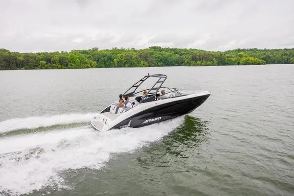 Slide: The Image of 2026 Yamaha AR250 boat cruising on a lake with lush green forest backdrop. - 3