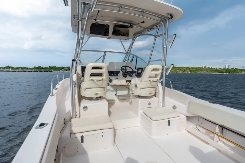 Slide: The Image of 2006 Grady-White Gulfstream 232 boat interior with helm and seating on open water. - 17