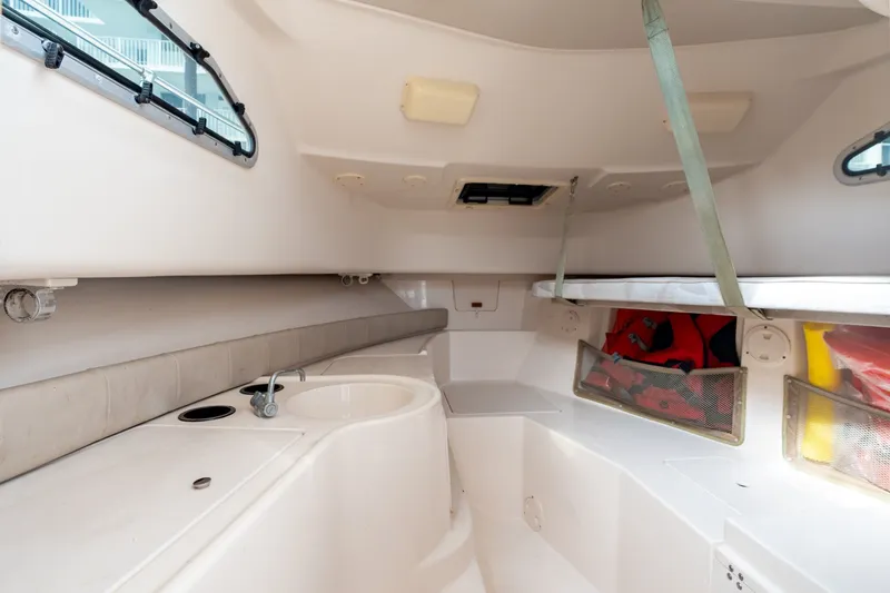 Slide: The Image of Interior cabin of 2006 Grady-White Gulfstream 232 boat, featuring seating and storage compartments. - 26