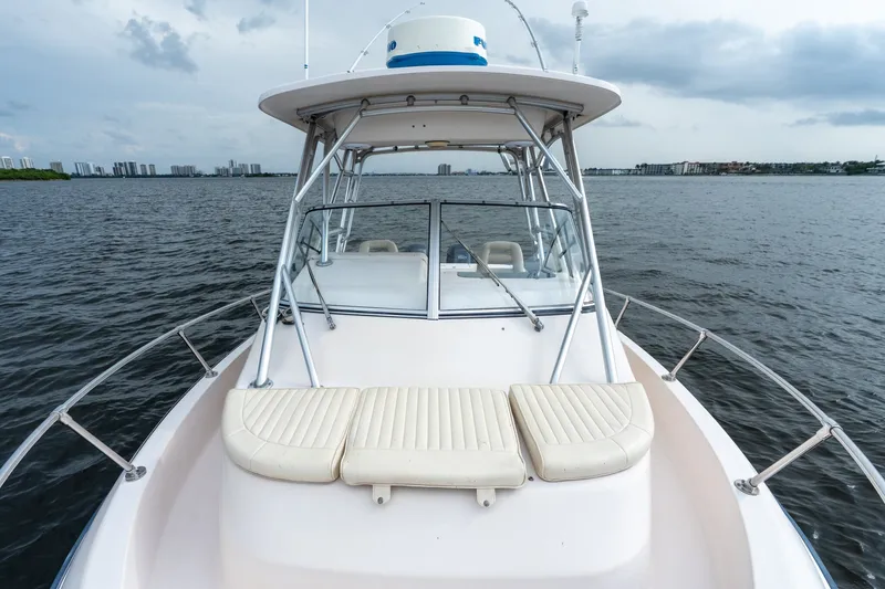 Slide: The Image of 2006 Grady-White Gulfstream 232 boat on water, featuring spacious deck and seating. - 23