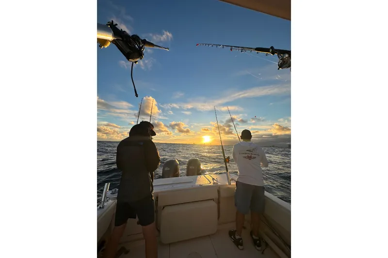 Slide: The Image of Two people fishing at sunset on a 2006 Grady-White Gulfstream 232 boat. - 8