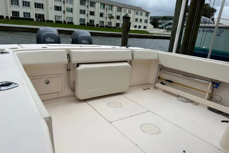 Slide: The Image of 2006 Grady-White Gulfstream 232 boat interior with Yamaha 150 engines, docked near waterfront buildings. - 4