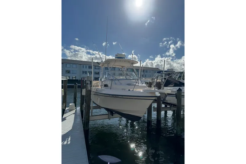 Slide: The Image of 2006 Grady-White Gulfstream 232 boat docked under sunny skies. - 1