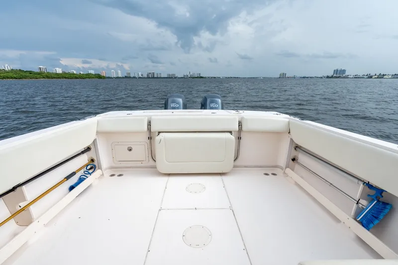Slide: The Image of 2006 Grady-White Gulfstream 232 boat on water with city skyline in background. - 19