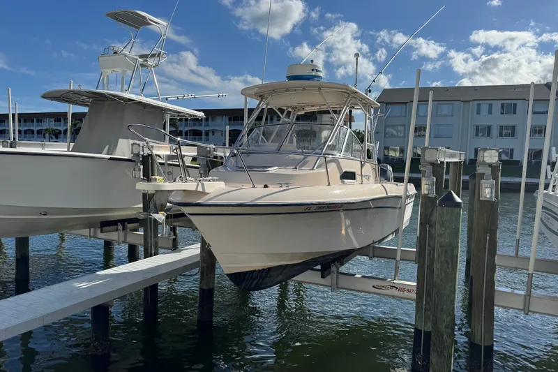 The Image of 2006 Grady-White Gulfstream 232 boat docked at marina under clear blue sky. - 0
