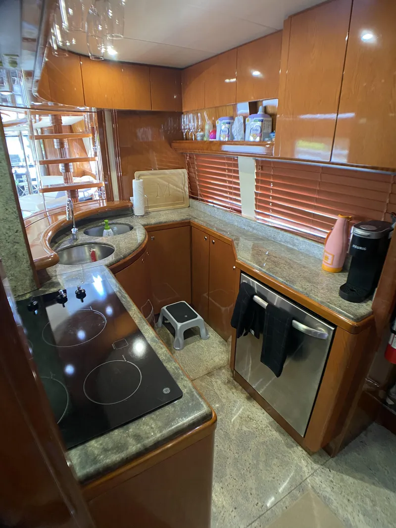 Slide: The Image of 1999 Azimut 85 Ultimate yacht kitchen with modern appliances and wooden cabinetry. - 24