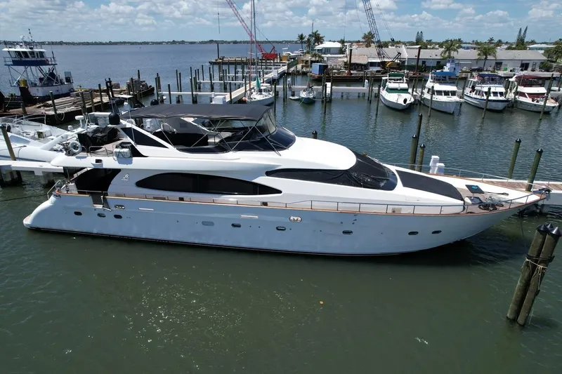 Slide: The Image of Luxury 1999 Azimut 85 Ultimate yacht docked at marina under clear skies. - 1