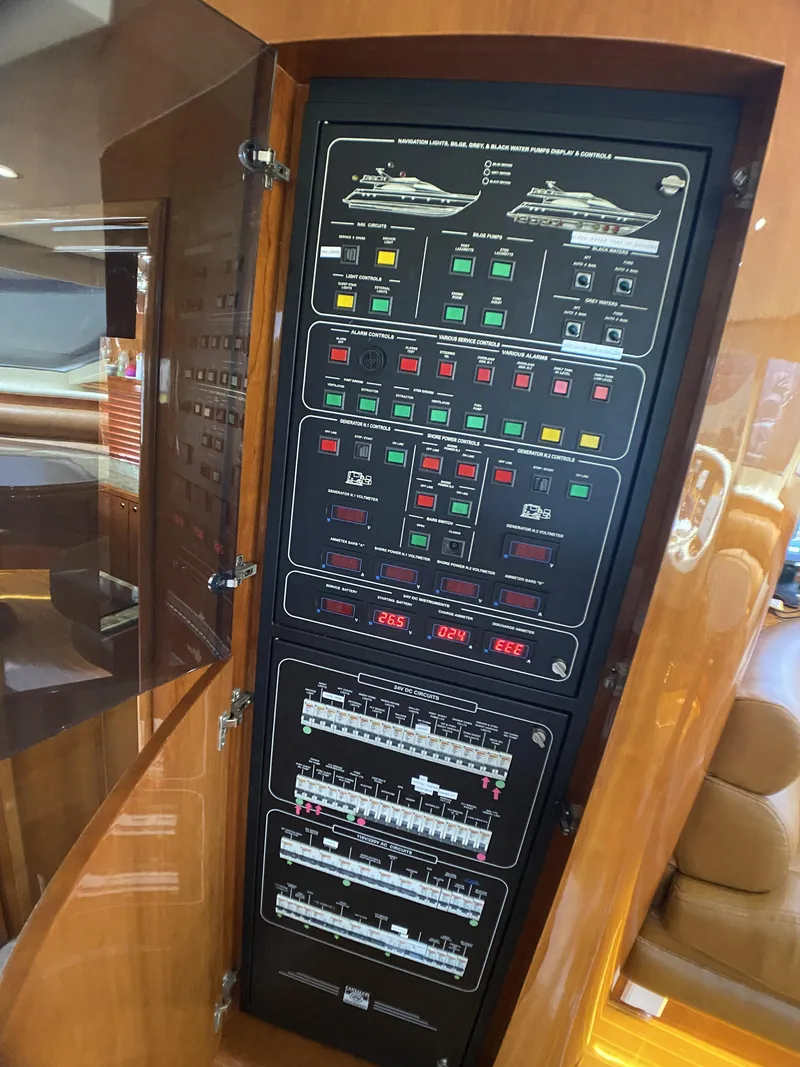 Slide: The Image of Control panel inside a 1999 Azimut 85 Ultimate yacht, featuring various switches and indicators. - 37