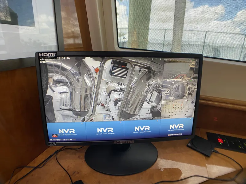 Slide: The Image of Monitor displaying engine room footage on a 1999 Azimut 85 Ultimate yacht. - 33