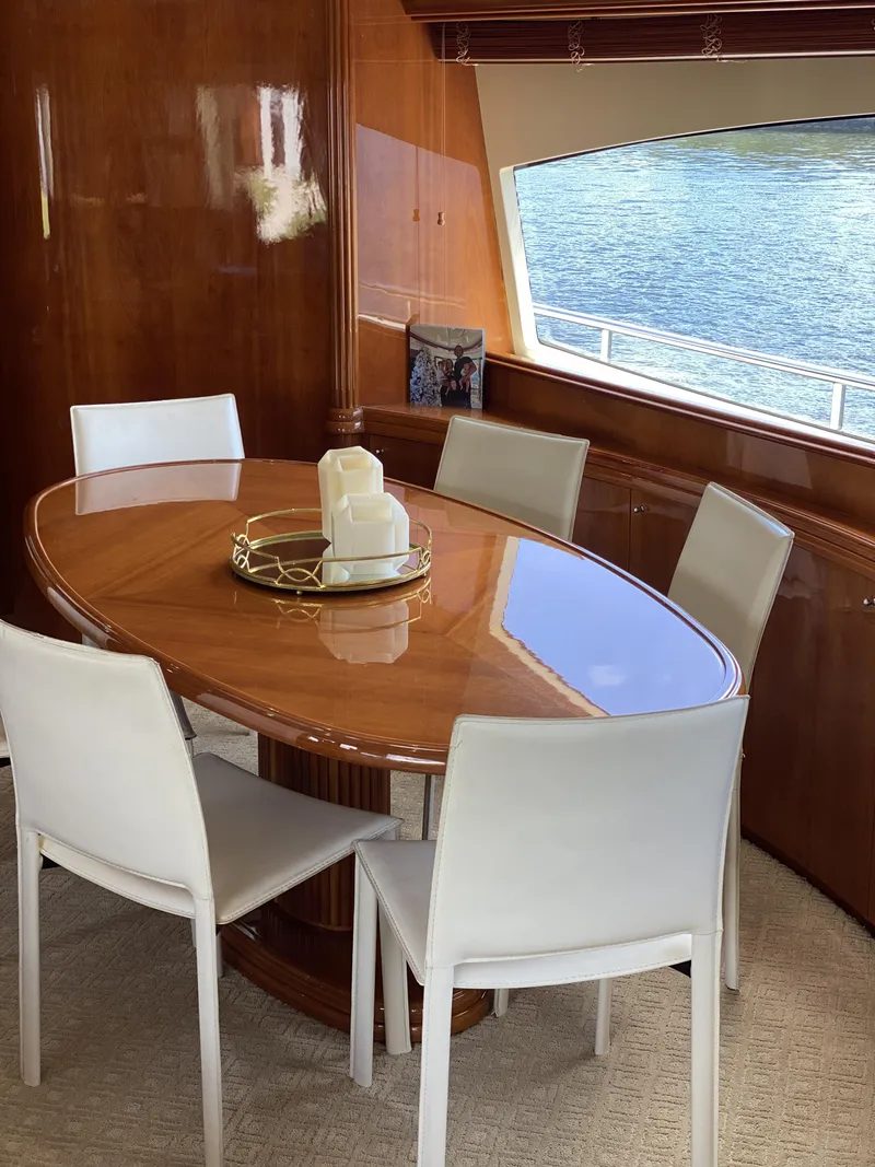 Slide: The Image of Dining area on 1999 Azimut 85 Ultimate yacht with elegant wooden table and white chairs. - 19