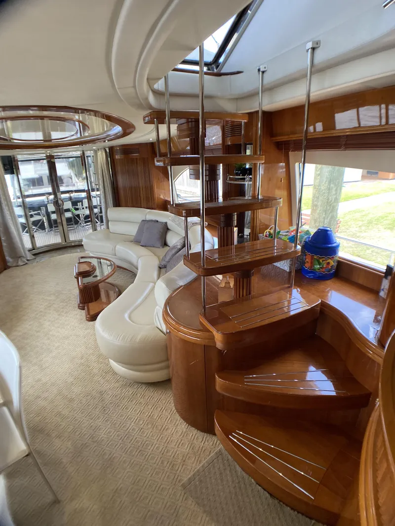 Slide: The Image of Luxurious interior of 1999 Azimut 85 Ultimate yacht with elegant wooden staircase and plush seating. - 38