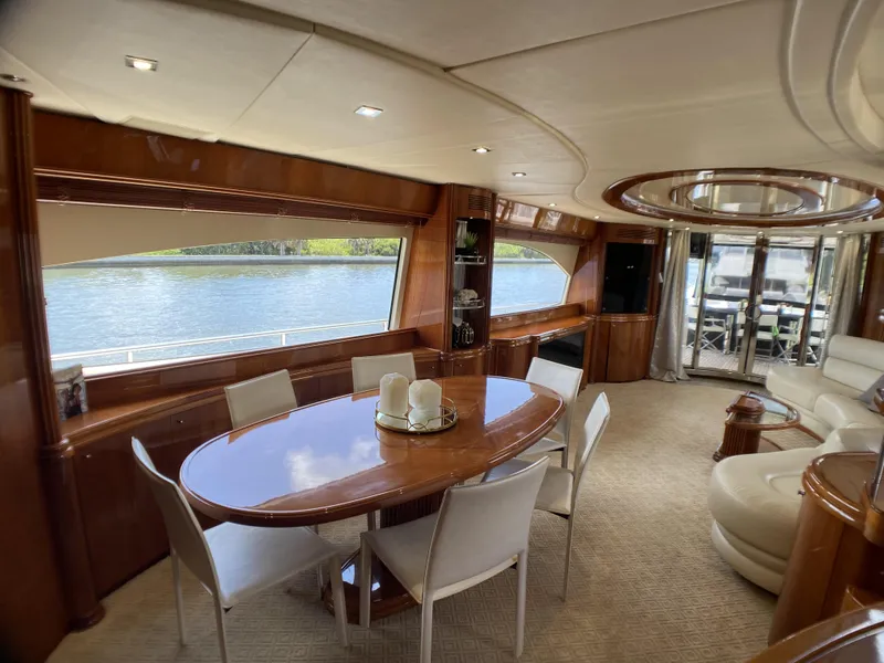 Slide: The Image of Luxurious interior of 1999 Azimut 85 Ultimate yacht with elegant dining area and scenic water views. - 14