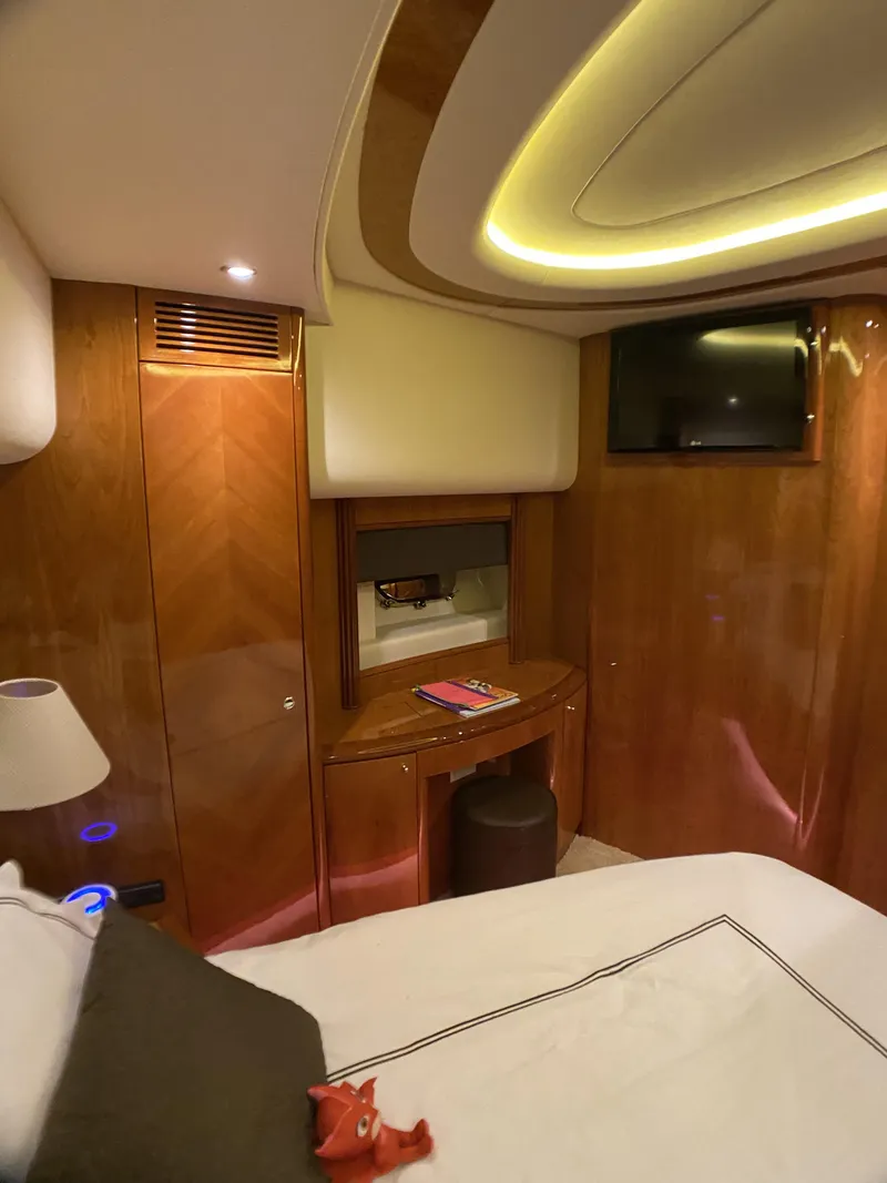Slide: The Image of Luxurious cabin interior of a 1999 Azimut 85 Ultimate yacht with elegant wood paneling. - 46