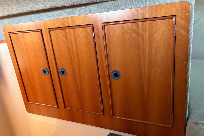 Slide: The Image of Wooden cabinet doors inside a 2003 PDQ 34 Power Catamaran, showcasing sleek design and craftsmanship. - 42
