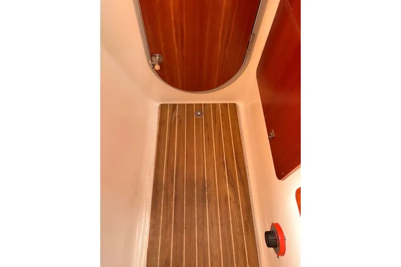 Slide: The Image of Interior view of 2003 PDQ 34 Power Catamaran with wooden flooring and door. - 48