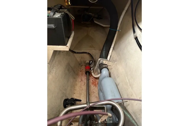 Slide: The Image of Engine compartment of a 2003 PDQ 34 Power Catamaran, showing battery and exhaust system. - 53