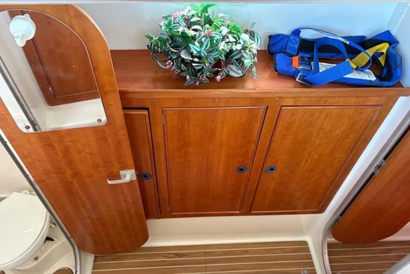 Slide: The Image of Wooden cabinetry and decor inside a 2003 PDQ 34 Power Catamaran bathroom. - 27