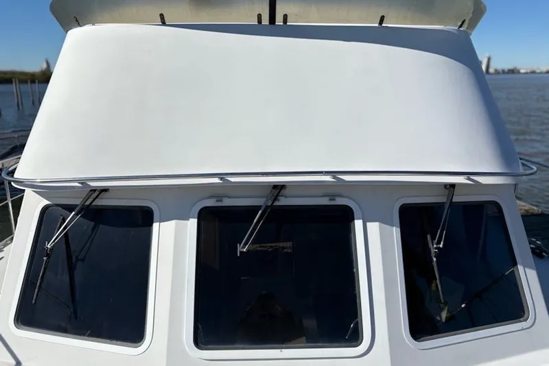 Slide: The Image of 2003 PDQ 34 Power Catamaran front view with windshield and wipers. - 15