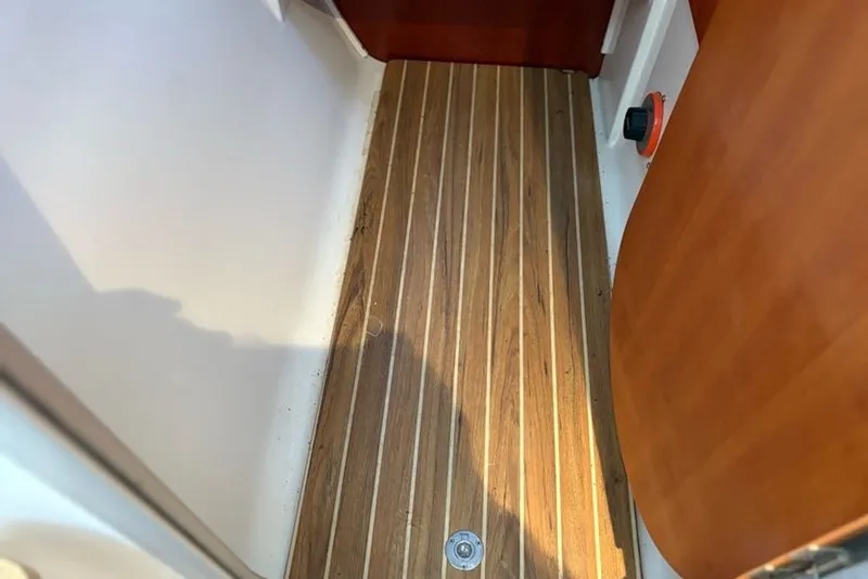Slide: The Image of Wooden flooring inside a 2003 PDQ 34 Power Catamaran, showcasing sleek design and craftsmanship. - 34