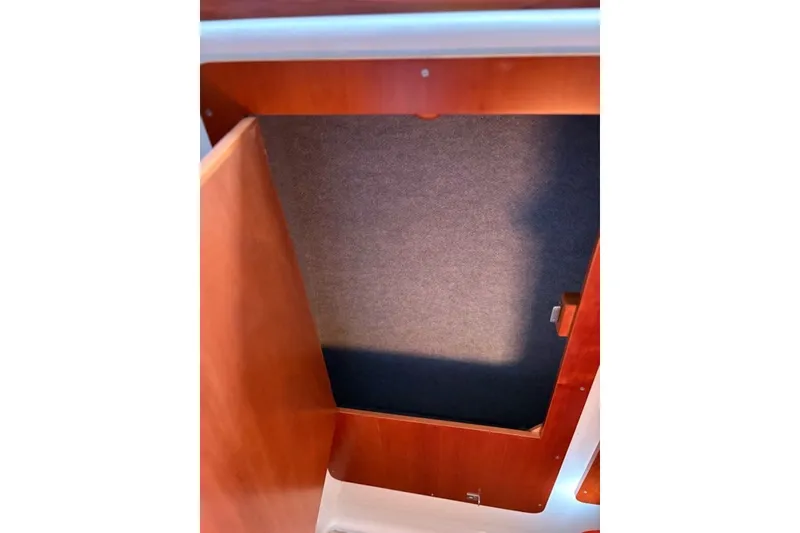 Slide: The Image of Open wooden cabinet inside 2003 PDQ 34 Power Catamaran. - 49