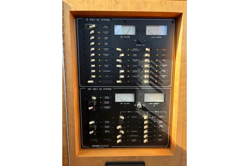 Slide: The Image of Electrical panel of a 2003 PDQ 34 Power Catamaran, featuring 12V DC and 120V AC systems. - 45