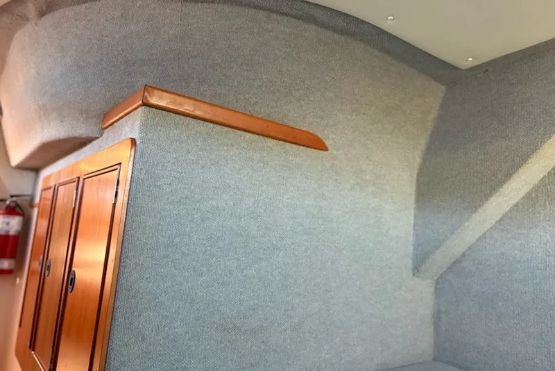 Slide: The Image of Interior of 2003 PDQ 34 Power Catamaran with wooden cabinets and fire extinguisher. - 40