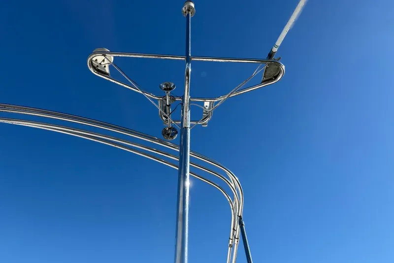 Slide: The Image of Stainless steel structure on 2003 PDQ 34 Power Catamaran against clear blue sky. - 18