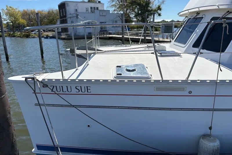 Slide: The Image of 2003 PDQ 34 Power Catamaran "Zulu Sue" docked by the waterfront. - 13