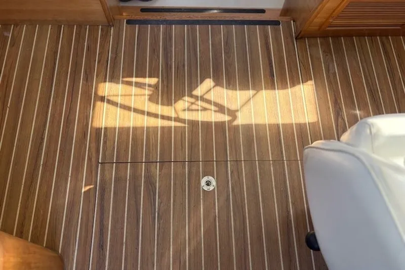 Slide: The Image of Wooden floor of 2003 PDQ 34 Power Catamaran with sunlight and white seat. - 20