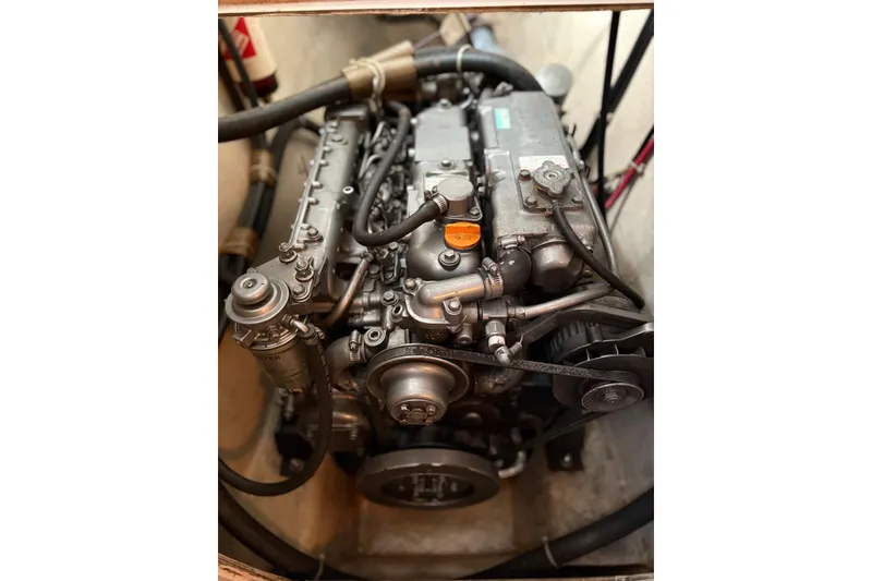 Slide: The Image of Engine of a 2003 PDQ 34 Power Catamaran, showcasing mechanical components and hoses. - 51