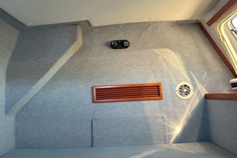 Slide: The Image of Interior of 2003 PDQ 34 Power Catamaran with carpeted walls and wooden vent. - 41