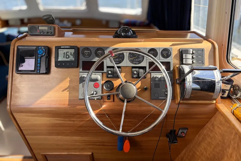 Slide: The Image of Helm of 2003 PDQ 34 Power Catamaran with navigation instruments and steering wheel. - 23