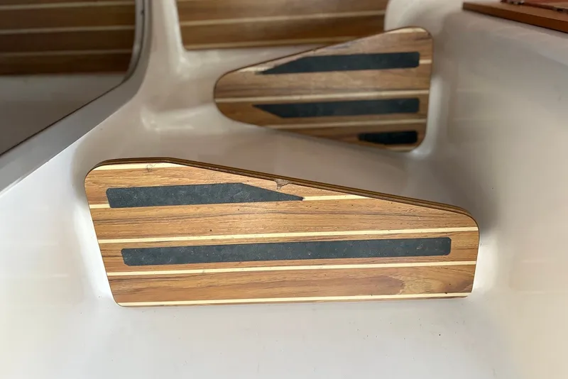 Slide: The Image of Wooden steps with black grip strips on a 2003 PDQ 34 Power Catamaran. - 19