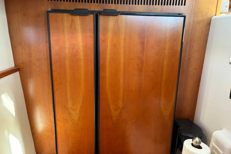 Slide: The Image of Wooden cabinet doors inside a 2003 PDQ 34 Power Catamaran. - 29
