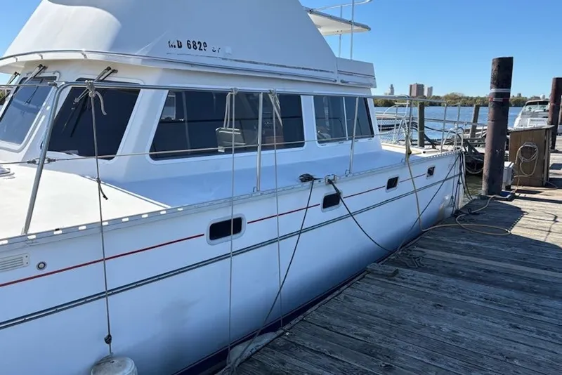 Slide: The Image of 2003 PDQ 34 Power Catamaran docked at a marina on a sunny day. - 14
