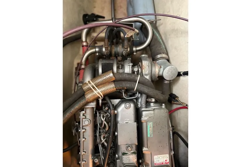 Slide: The Image of Engine compartment of 2003 PDQ 34 Power Catamaran with visible hoses and components. - 52