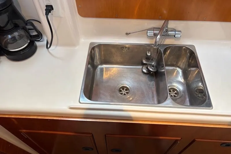 Slide: The Image of Stainless steel sink and faucet in 2003 PDQ 34 Power Catamaran galley. - 32