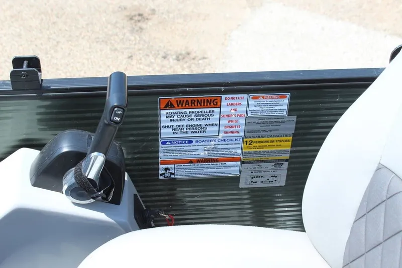 Slide: The Image of Control panel and safety warnings on a 2023 Bennington 23 LSR boat. - 19