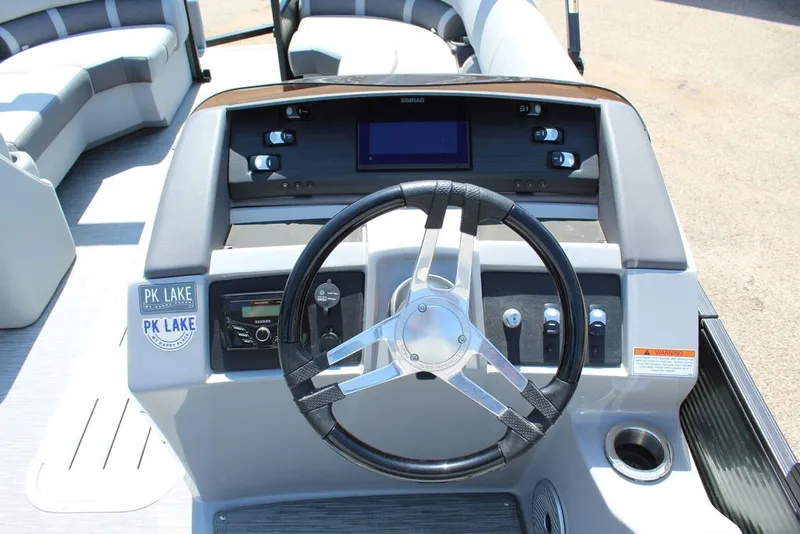 Slide: The Image of 2023 Bennington 23 LSR boat dashboard with steering wheel and control panel. - 12