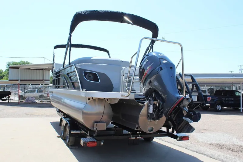 Slide: The Image of 2023 Bennington 23 LSR pontoon boat with Yamaha outboard motor on trailer. - 4